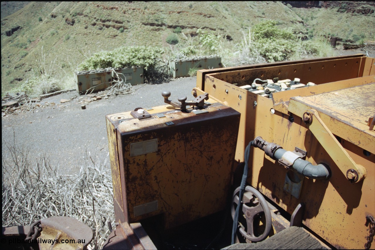 198-03
Wittenoom, Colonial Mine, asbestos mining remains, view of driving position, throttle and battery box of battery locomotive GEMCO Hauler serial No. 12304-05/10/65, motor H.P. 2/11, volts 80, drawbar pull (lbs.) 1250 built by George Moss Pty Ltd Leederville, WA. The wheel is the handbrake.
Keywords: Gemco;George-Moss;12304-05/10/65;