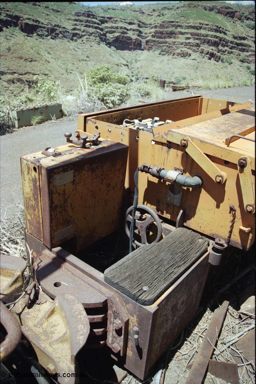 198-04
Wittenoom, Colonial Mine, asbestos mining remains, view of driving position, throttle and battery box of battery locomotive GEMCO Hauler serial 12304-05/10/65, motor H.P. 2/11, volts 80, drawbar pull (lbs.) 1250 built by George Moss Pty Ltd Leederville, WA. The wheel is the handbrake.
Keywords: Gemco;George-Moss;12304-05/10/65;