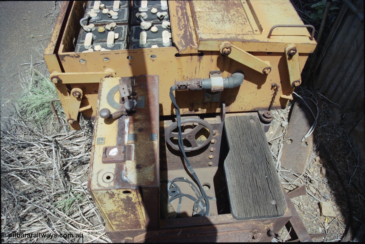 198-09
Wittenoom, Colonial Mine, asbestos mining remains, view of driving position, reverser and throttle, brake wheel, timber seat, battery plug and battery box of battery locomotive GEMCO Hauler serial 12304-05/10/65, motor H.P. 2/11, volts 80, drawbar pull (lbs.) 1250 built by George Moss Pty Ltd Leederville, WA.
Keywords: Gemco;George-Moss;12304-05/10/65;