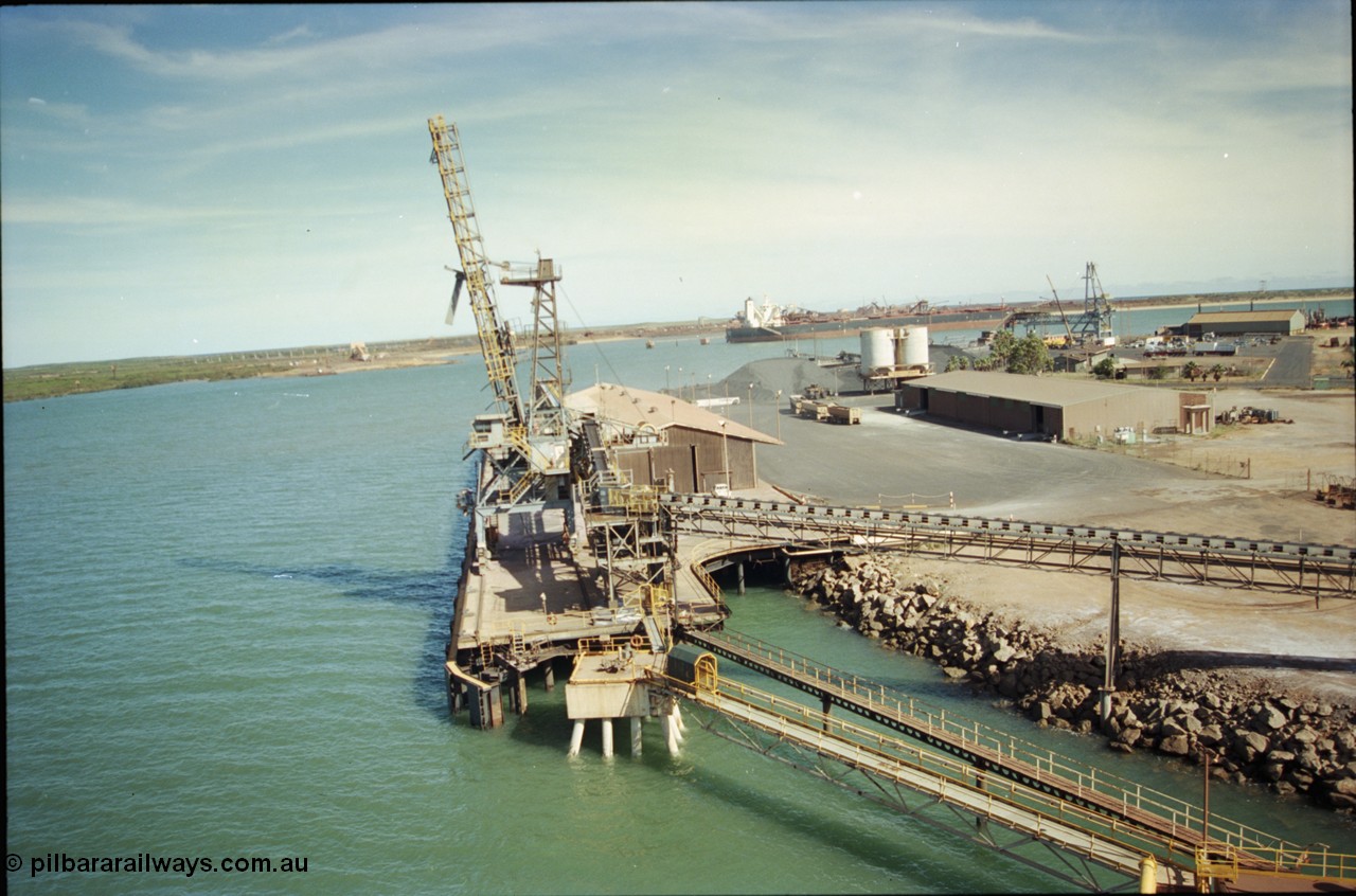 198-15
Port Hedland Port, view of the Cargill Salt berth and loader, or PHPA Berth No. 3, in this 2001 view, the then new bulker loader is under construction and manganese is stockpiled on the ground. The BHP Finucane Island berth is visible along with the overland conveyor for the HBI plant.
