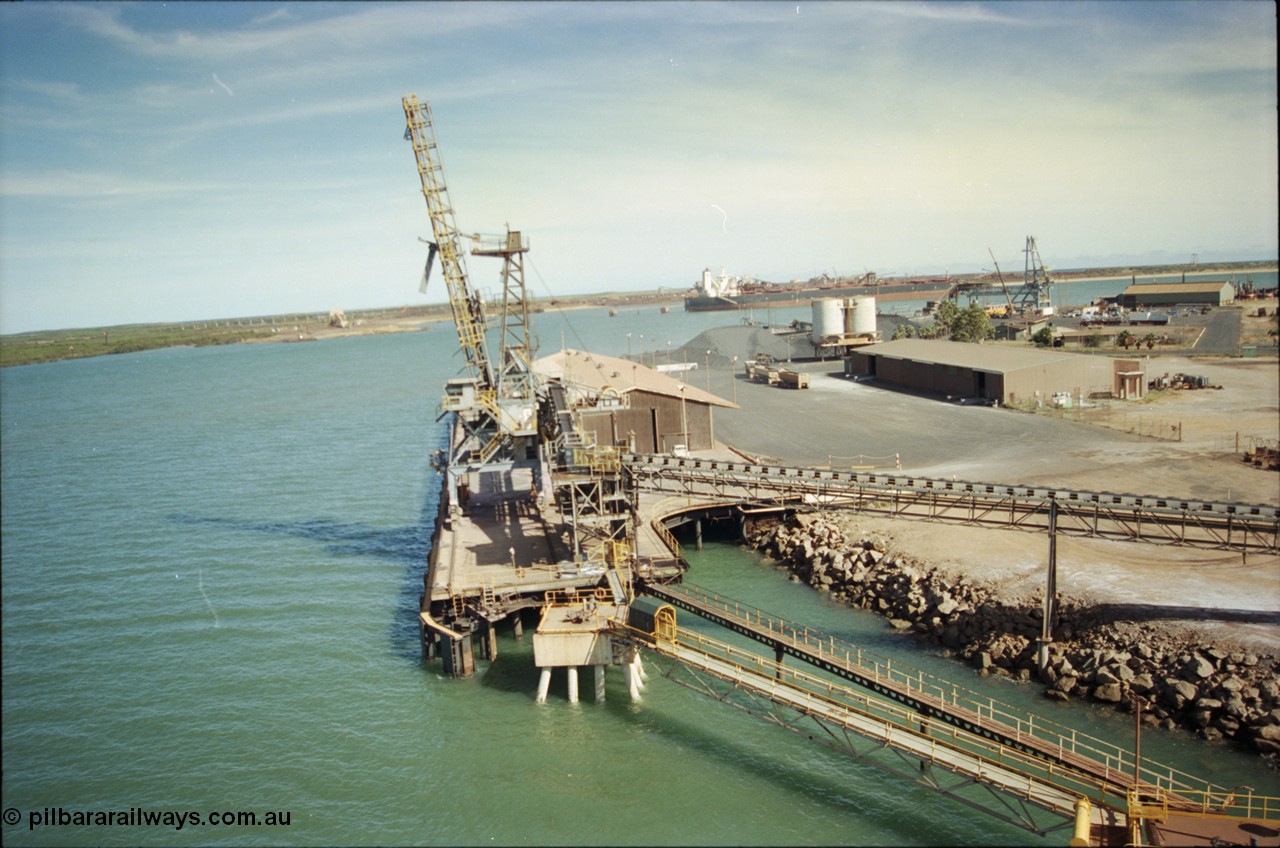 198-16
Port Hedland Port, view of the Cargill Salt berth and loader, or PHPA Berth No. 3, in this 2001 view, the then new bulker loader is under construction and manganese is stockpiled on the ground. The BHP Finucane Island berth is visible along with the overland conveyor for the HBI plant.
