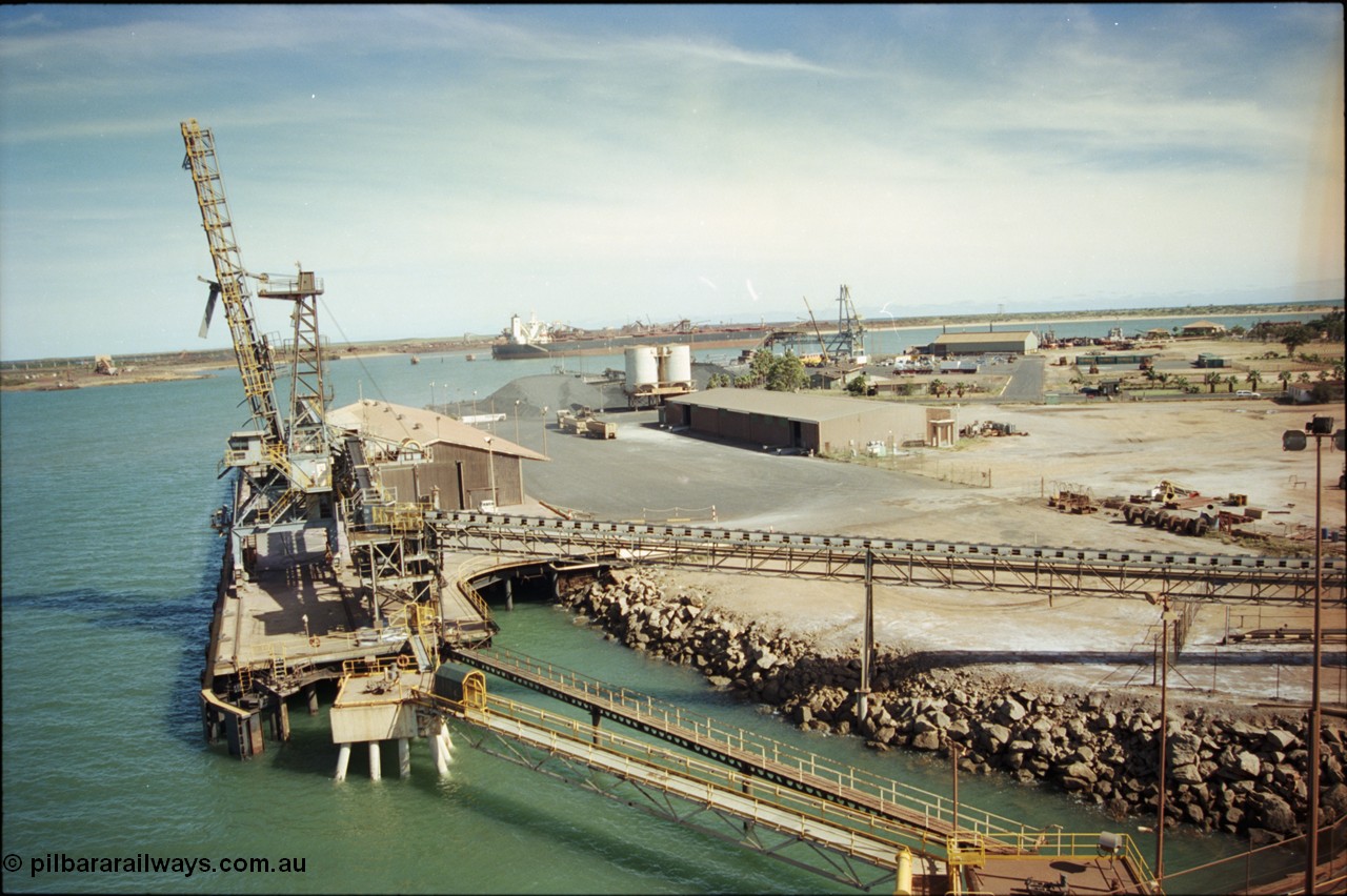 198-17
Port Hedland Port, view of the Cargill Salt berth and loader, or PHPA Berth No. 3, in this 2001 view, the then new bulker loader is under construction and manganese is stockpiled on the ground. The BHP Finucane Island berth is visible along with the overland conveyor for the HBI plant.

