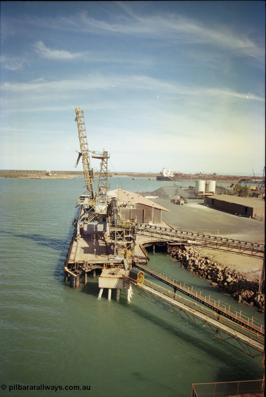198-18
Port Hedland Port, view of the Cargill Salt berth and loader, or PHPA Berth No. 3, in this 2001 view, the then new bulker loader is under construction and manganese is stockpiled on the ground. The BHP Finucane Island berth is visible along with the overland conveyor for the HBI plant.
