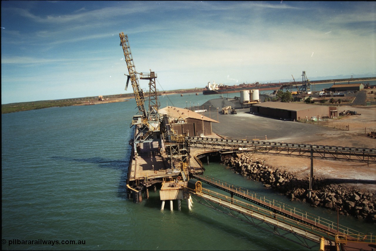 198-19
Port Hedland Port, view of the Cargill Salt berth and loader, or PHPA Berth No. 3, in this 2001 view, the then new bulker loader is under construction and manganese is stockpiled on the ground. The BHP Finucane Island berth is visible along with the overland conveyor for the HBI plant.
