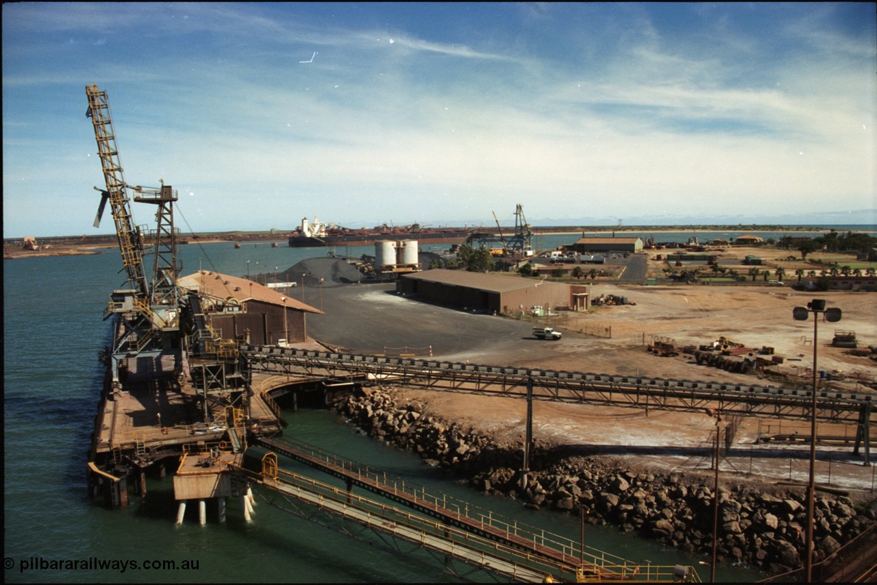 198-22
Port Hedland Port, view of the Cargill Salt berth and loader, or PHPA Berth No. 3, in this 2001 view, the then new bulker loader is under construction and manganese is stockpiled on the ground. The BHP Finucane Island berth is visible along with the overland conveyor for the HBI plant, in the far background is the admin building for BHP Transport the operator of the Tug Boats.
