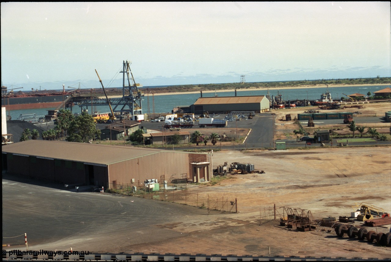 198-24
Port Hedland Port, overview of the hard stand area, salt conveyor at very bottom of image. New bulk loader under construction, tug pen and BHP Transport admin building visible at top right. Circa 2001.
