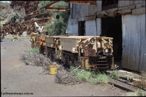 198-07
Wittenoom, Colonial Mine, asbestos mining remains, line up of two Mancha locomotives and the Gemco, then an English Electric. In the background is the demolished locomotive changing and maintenance shed. The building on the right is the compressor and water treatment plant sheds, the lead unit has Wittenoom Exprss stencilled on the battery box, this unit now resides at the Pilbara Railways Historical Society near the 7 Mile complex in Dampier.
Keywords: Mancha;English-Electric;Gemco;