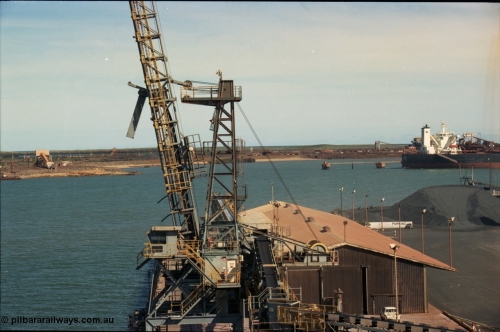 198-29
Port Hedland Port, view of Cargill Salt loader on No. 3 Berth, BHP under-harbour tunnel portal and overland conveyor for HBI plant visible along with Finucane Island, 2001.
