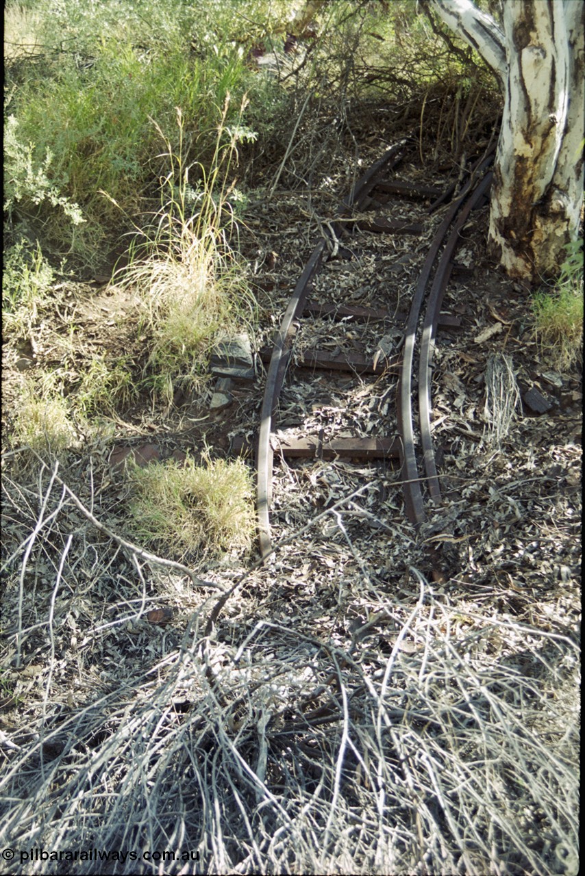 204-27
Wittenoom Gorge Mine, remains of asbestos mining, narrow gauge rail track section with extra inside rail to prevent derailments.
