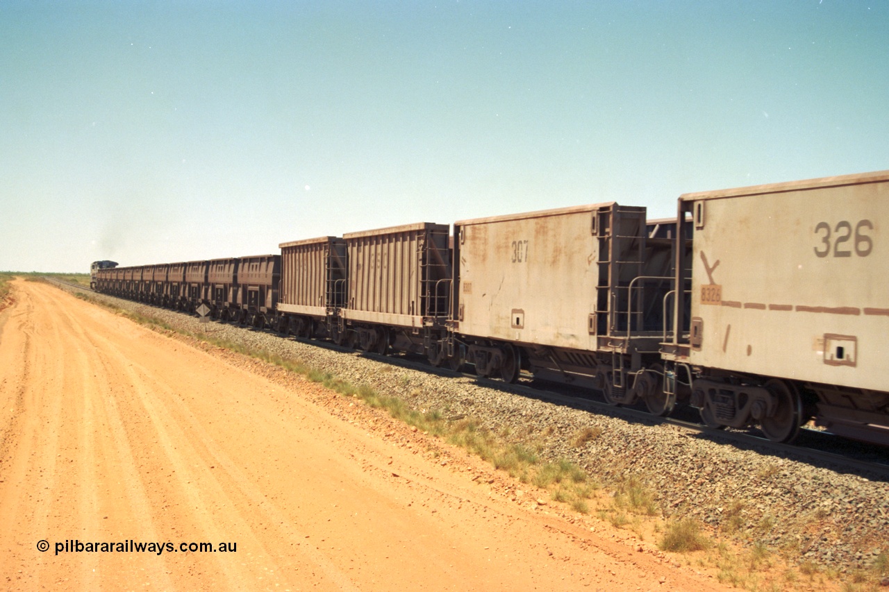 206-32
An empty train on the Yarrie (former Goldsworthy) line with a string of Golynx ore waggons, built by Goninan WA to a Lynx Engineering design, and then the two types of the waggons from the Phelps Dodge Copper Mine, the ribbed units are built by Portec USA and the smooth ones built by Gunderson USA. All of these are belly dump waggons as opposed to the BHP fleet of rotary dump bodies.
Keywords: 8307;Gunderson-USA;BHP-ore-waggon;
