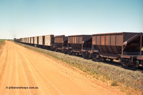 206-33
An empty train on the Yarrie (former Goldsworthy) line with a string of Golynx ore waggons, built by Goninan WA to a Lynx Engineering design, and then the two types of the waggons from the Phelps Dodge Copper Mine, the ribbed units are built by Portec USA and the smooth ones built by Gunderson USA and finally the Tomlinson Steel WA built hopper waggons. All of these are belly dump waggons as opposed to the BHP fleet of rotary dump bodies.
Keywords: 8185;Tomlinson-Steel-WA;BHP-ore-waggon;