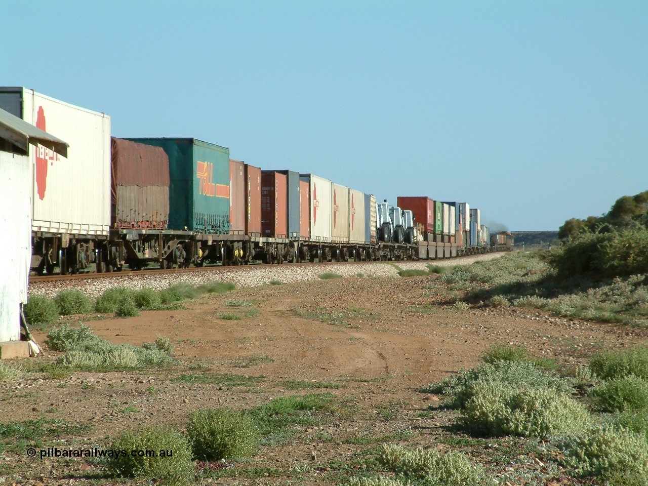 030404 082909
Port Germein, Perth bound steel and intermodal hurries through on the main behind National Rail's NR class units, showing one and a half stacking and new vehicles on flat waggons. 4th April 2003.
