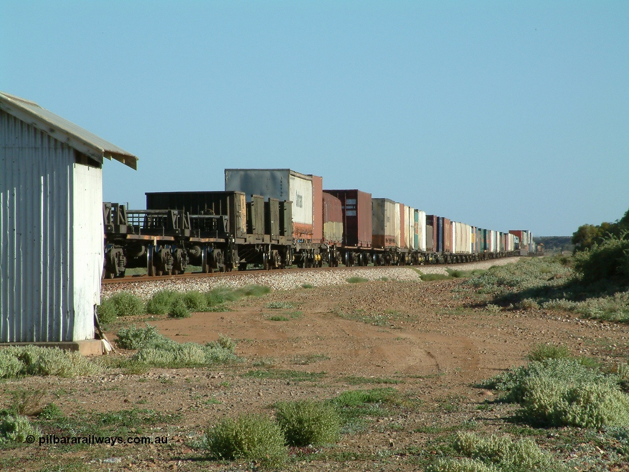 030404 082938
Port Germein, Perth bound steel and intermodal hurries through on the main behind National Rail's NR class units, showing one and a half stacking and new vehicles on flat waggons with empty steel loading on the rear. 4th April 2003.
