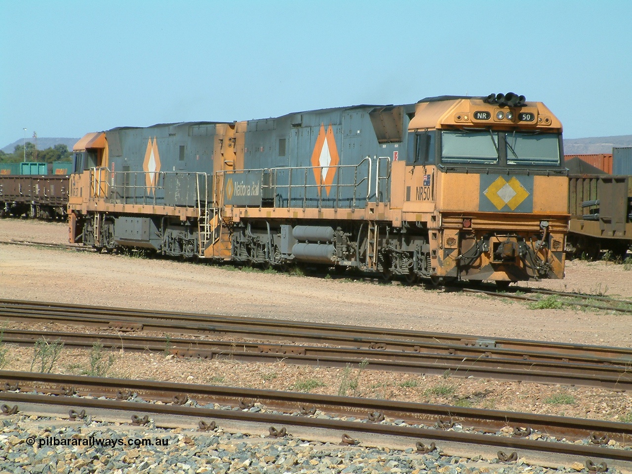 030404 103651
Port Augusta Spencer Junction yard, National Rail Goninan built GE Cv40-9i model NR class unit NR 50 serial 7250-08 / 97-252 lay about the yard in between jobs. 4th April 2003.
Keywords: NR-class;NR50;7250-08/97-252;Goninan;GE;Cv40-9i;