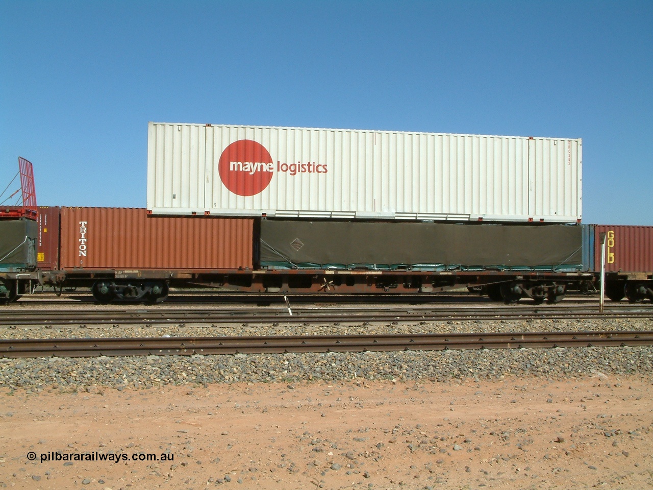 030404 104048
Port Augusta Spencer Junction yard, RQKY type 60' container flat waggon fitted with aligned bogies RQKY 2690 was originally built by Perry Engineering SA in 1974 in a batch of forty five RM type container waggon, fitted with aligned bogies and recoded to AQPY type. Seen here with a Mayne Logistics 48' DRC 382 container on top of a 40' half height tarped load. 4th April 2003.
Keywords: RQKY-type;RQKY2690;Perry-Engineering-SA;RM-type;AQPY-type;AQMP-type;