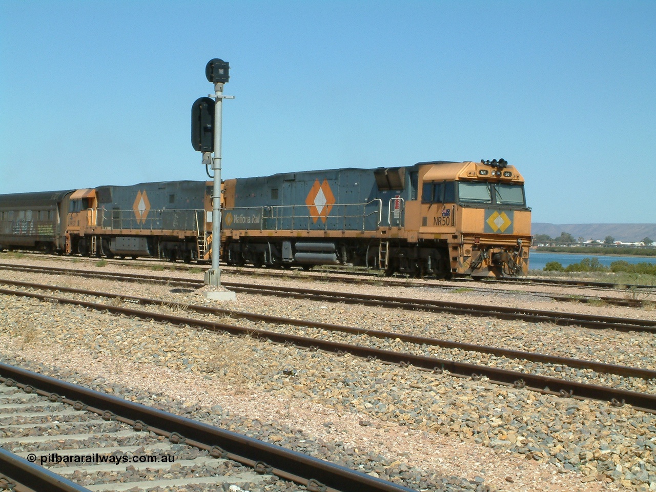 030404 125101
Port Augusta Spencer Junction yard, a Perth bound intermodal awaits departure time on 13 Road behind National Rail NR class units built by Goninan as GE Cv40-9i models, NR 50 serial 7250-08 / 97-252 and NR 37 serial 7250-06 / 97-239. 4th April 2003.
Keywords: NR-class;NR50;7250-08/97-252;Goninan;GE;Cv40-9i;