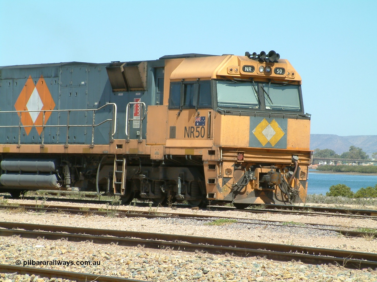 030404 125115
Port Augusta Spencer Junction yard, a Perth bound intermodal awaits departure time on 13 Road behind National Rail NR class units built by Goninan as GE Cv40-9i models, NR 50 serial 7250-08 / 97-252. 4th April 2003.
Keywords: NR-class;NR50;7250-08/97-252;Goninan;GE;Cv40-9i;