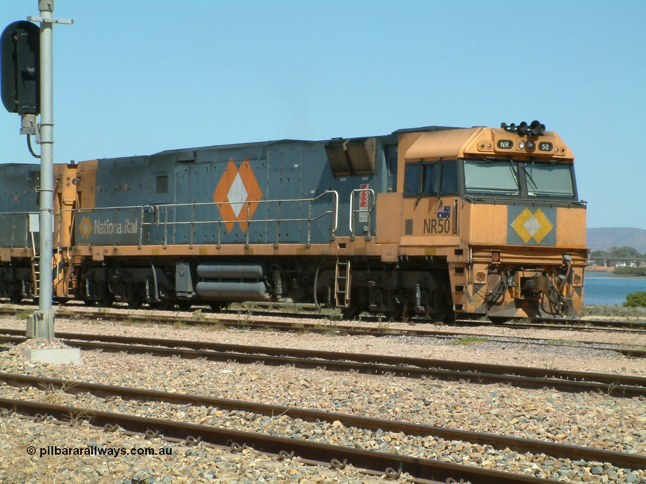 030404 125126
Port Augusta Spencer Junction yard, a Perth bound intermodal awaits departure time on 13 Road behind National Rail NR class units built by Goninan as GE Cv40-9i models, NR 50 serial 7250-08 / 97-252. 4th April 2003.
Keywords: NR-class;NR50;7250-08/97-252;Goninan;GE;Cv40-9i;