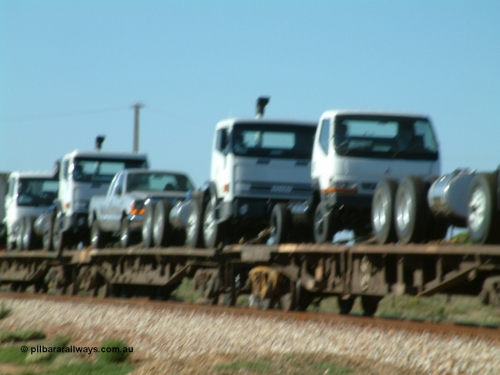 030404 082847
Port Germein, Perth bound steel and intermodal hurries through on the main, out of focus shot of new vehicles loaded on flat waggons. 4th April 2003.
