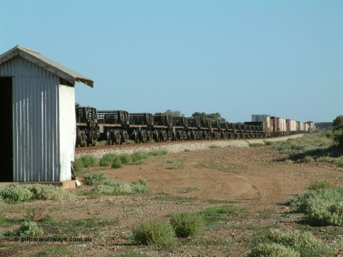 030404 082951
Port Germein, Perth bound steel and intermodal hurries through on the main showing the 3-pack steel billet transport waggons. These RKKY waggons were built by ANI Engineering from a Williams-Worley Rail design in 1993 and operate between Whyalla and Newcastle. 4th April 2003.
Keywords: RKKY-type;ANI-Engineering-NSW;Williams-Worley;RKKF-type;