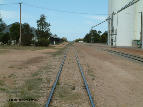 030405 132832
Wudinna, yard view looking along the mainline south with Naylor Tce in the background with grain shed on the left and silo complex and loading spout on the right, April 5, 2003.
