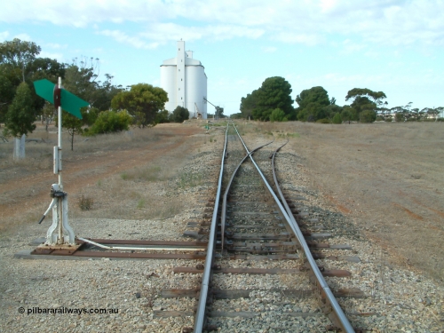 030406 091232
Yeelanna, station located at the 81.7 km, original terminus of line in April 1909, then junction for line to Mount Hope in October 1914. Station yard overview from the north end points looking south, point lever and indicators, goods ramp, crane and concrete silo complex on the left. 6th April 2003.
