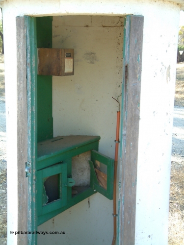 030406 095944
Cummins, view inside the concrete train control booth, shows writing desk and box on wall with phone inside. 6th April 2003.
