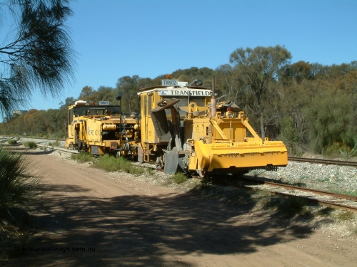 030406 110700
Coomunga, on the siding, two Transfield track machines, TMN 02, a ballast regulator and a track tamper. 6th April 2003.
Keywords: track-machine;