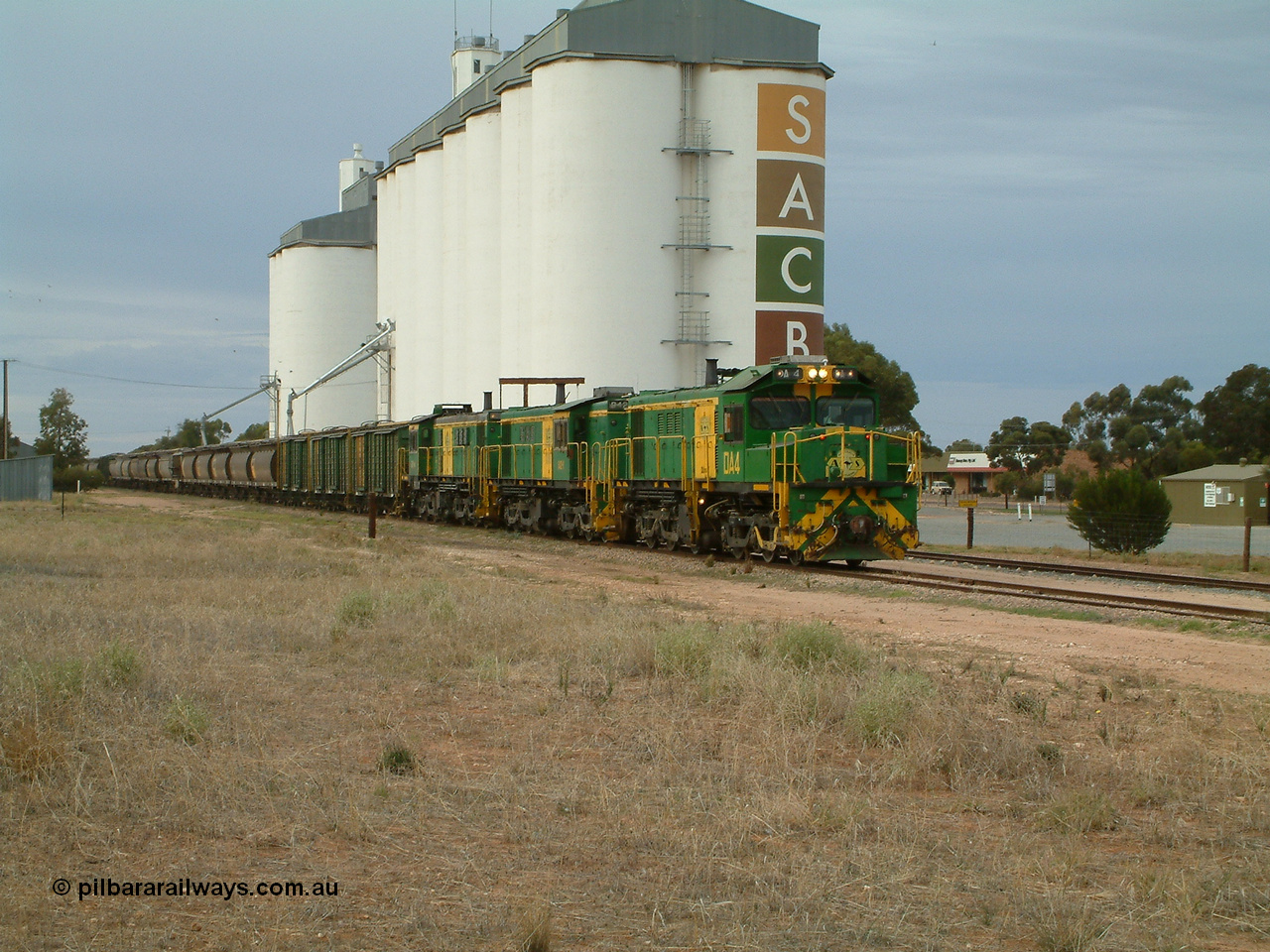 030407 082231
Wudinna, north bound empty grain train arrives behind a trio of former Australian National locomotives with rebuilt former AE Goodwin ALCo model DL531 830 class ex 839, serial 83730, rebuilt by Port Augusta Workshops to DA class, DA 4 leading two AE Goodwin ALCo model DL531 830 class units 842, serial 84140 and 851 serial 84137, 851 having been on the Eyre Peninsula since delivered in 1962, to shunt off empty waggons into the grain siding. 7th April 2003.
Keywords: DA-class;DA4;83730;Port-Augusta-WS;ALCo;DL531G/1;830-class;839;rebuild;