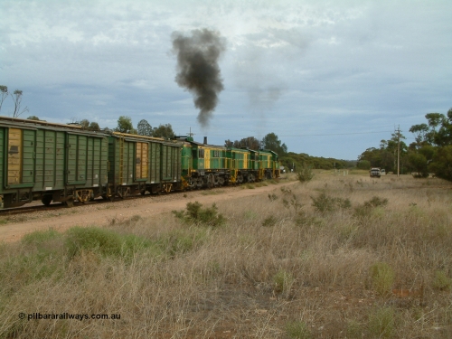 030407 082313
Wudinna, empty grain train shunts forward with a trio of former Australian National locomotives with rebuilt former AE Goodwin ALCo model DL531 830 class ex 839, serial 83730, rebuilt by Port Augusta Workshops to DA class, DA 4 leading two AE Goodwin ALCo model DL531 830 class units 842, serial 84140 and 851 serial 84137, 851 having been on the Eyre Peninsula since delivered in 1962, to shunt off empty waggons into the grain siding. 7th April 2003.
Keywords: DA-class;DA4;83730;Port-Augusta-WS;ALCo;DL531G/1;830-class;839;rebuild;