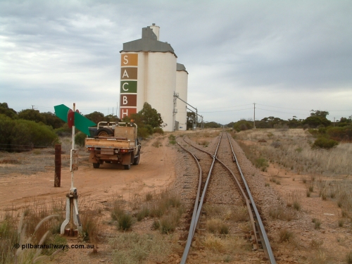 030407 085559
Yaninee, station yard overview looking north for the south end, concrete SACBH silo complexes, points, lever and indicator, mainline can be seen running straight into the distance. 7th April, 2003.
