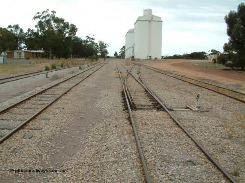 030407 094734
Minnipa, yard overview looking south, tracks from the left, No. 1 Goods Siding, Mainline, No.2 Goods Siding and No. 3 Goods Siding. Crew barracks visible on the left, rotating jib crane visible in front of concrete silo complexes. April 7, 2003.

