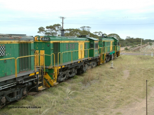 030407 100500
Minnipa, north bound empty grain train shunts across the grade crossing for Minnipa - Yardea Rd behind a trio of former Australian National Co-Co locomotives with rebuilt former AE Goodwin ALCo model DL531 830 class ex 839, serial no. 83730, rebuilt by Port Augusta Workshops to DA class, leading two AE Goodwin ALCo model DL531 830 class units 842, serial no. 84140 and 851 to shunt off empty waggons into the grain siding. April 7, 2003.
Keywords: 830-class;842;AE-Goodwin;ALCo;DL531;84140;
