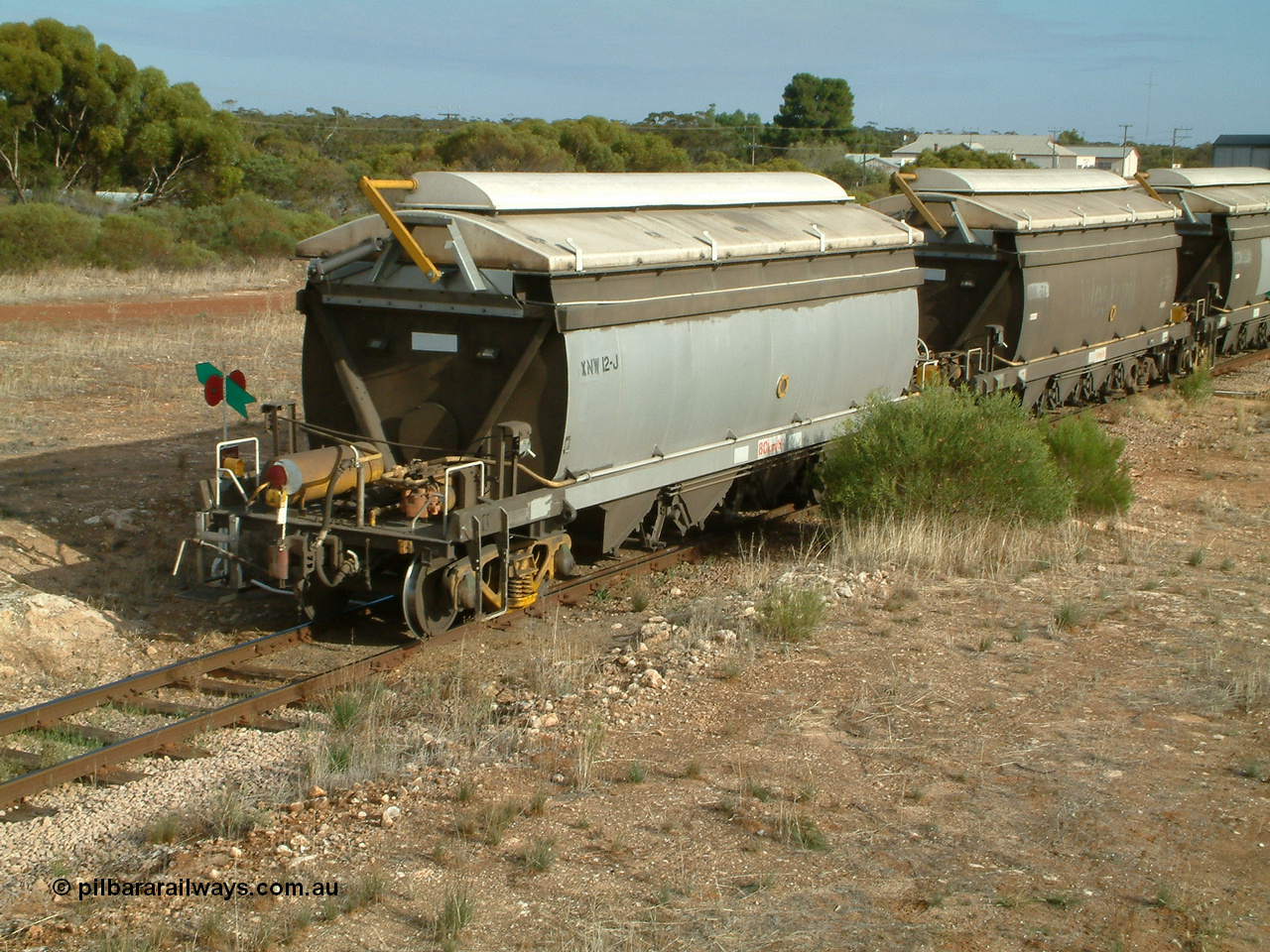 030409 084713
Kyancutta, XNW type bogie grain hopper waggon XNW 12 on the rear of a string of twelve such waggons, Comeng Qld built XNG type bogie waggon for Norseman Goldmines NL, then WAGR owned and coded XNA then in 1994 converted to XNW grain waggons. They arrived on the Eyre Peninsula system from 2001.
Keywords: XNW-type;XNW12;Comeng-Qld;XNG-type;XNA-type;
