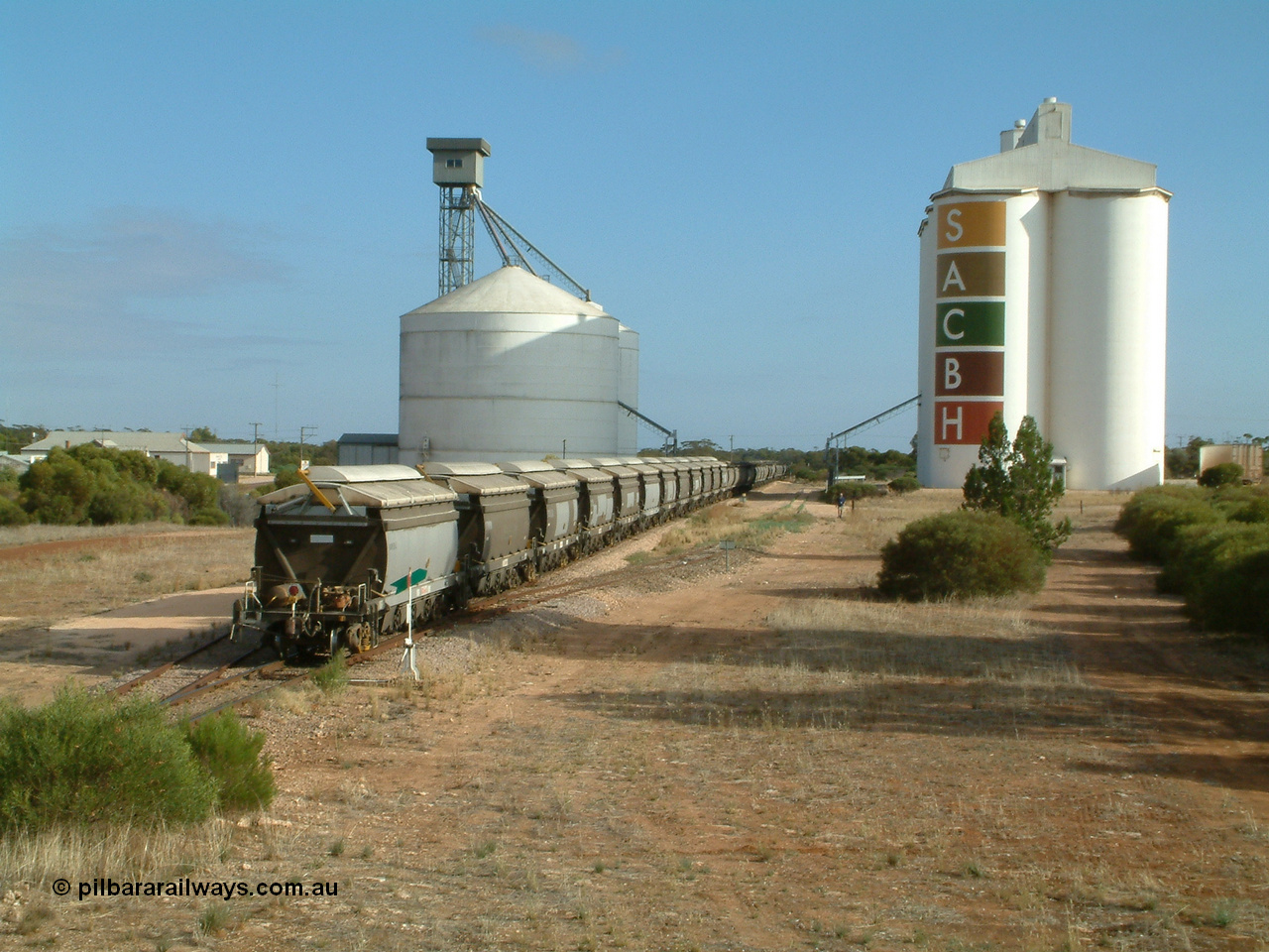 030409 084719
Kyancutta, XNW type bogie grain hopper waggon XNW 12 on the rear of a string of twelve such waggons, Comeng Qld built XNG type bogie waggon for Norseman Goldmines NL, then WAGR owned and coded XNA then in 1994 converted to XNW grain waggons. They arrived on the Eyre Peninsula system from 2001.
Keywords: XNW-type;XNW12;Comeng-Qld;XNG-type;XNA-type;