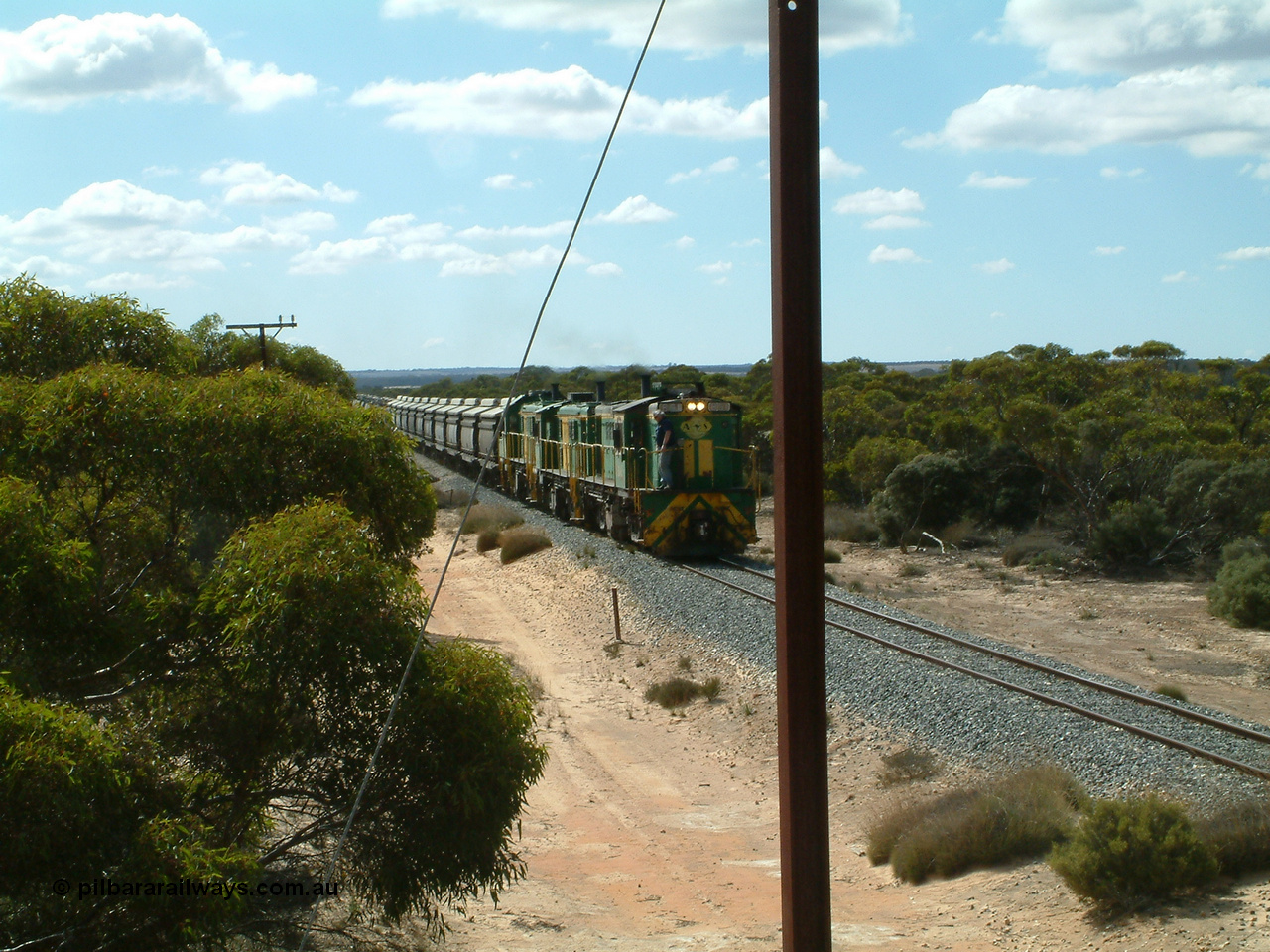 030409 110601
Caralue, loaded grain train working south of the former station site while one driver has a smoke, 830 class unit 851 AE Goodwin ALCo model DL531 serial 84137, 851 has spent its entire operating career on the Eyre Peninsula, it leads fellow 830 class 842 serial 84140 and a rebuilt unit DA 4, rebuilt from 830 class unit 839 by Port Augusta Workshops, retains original serial 83730 and model DL531.
Keywords: 830-class;851;84137;AE-Goodwin;ALCo;DL531;