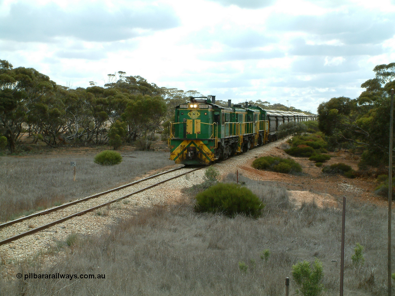 030409 115551
Darke Peake, at the 195 km Dog Fence Road grade crossing loaded grain train with 830 class unit 851 AE Goodwin ALCo model DL531 serial 84137, 851 has spent its entire operating career on the Eyre Peninsula, leads fellow 830 class 842 serial 84140 and a rebuilt unit DA 4, rebuilt from 830 class unit 839 by Port Augusta Workshops, retains original serial 83730 and model DL531 with the first twelve waggons behind the locos XNW type.
Keywords: 830-class;851;84137;AE-Goodwin;ALCo;DL531;