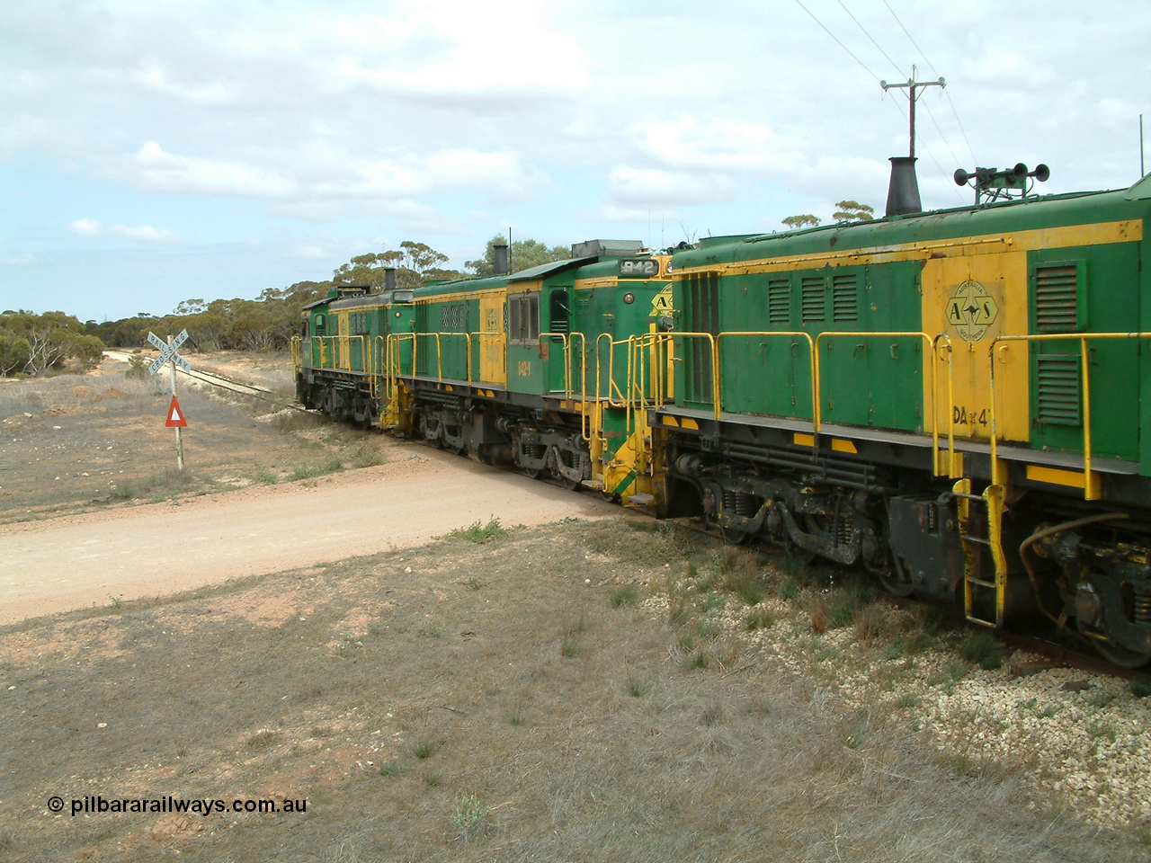 030409 115614
Darke Peake, at the 195 km Dog Fence Road grade crossing loaded grain train with 830 class unit 851 AE Goodwin ALCo model DL531 serial 84137, 851 has spent its entire operating career on the Eyre Peninsula, leads fellow 830 class 842 serial 84140 and a rebuilt unit DA 4, rebuilt from 830 class unit 839 by Port Augusta Workshops, retains original serial 83730 and model DL531 with the first twelve waggons behind the locos XNW type.
Keywords: 830-class;842;84140;AE-Goodwin;ALCo;DL531;
