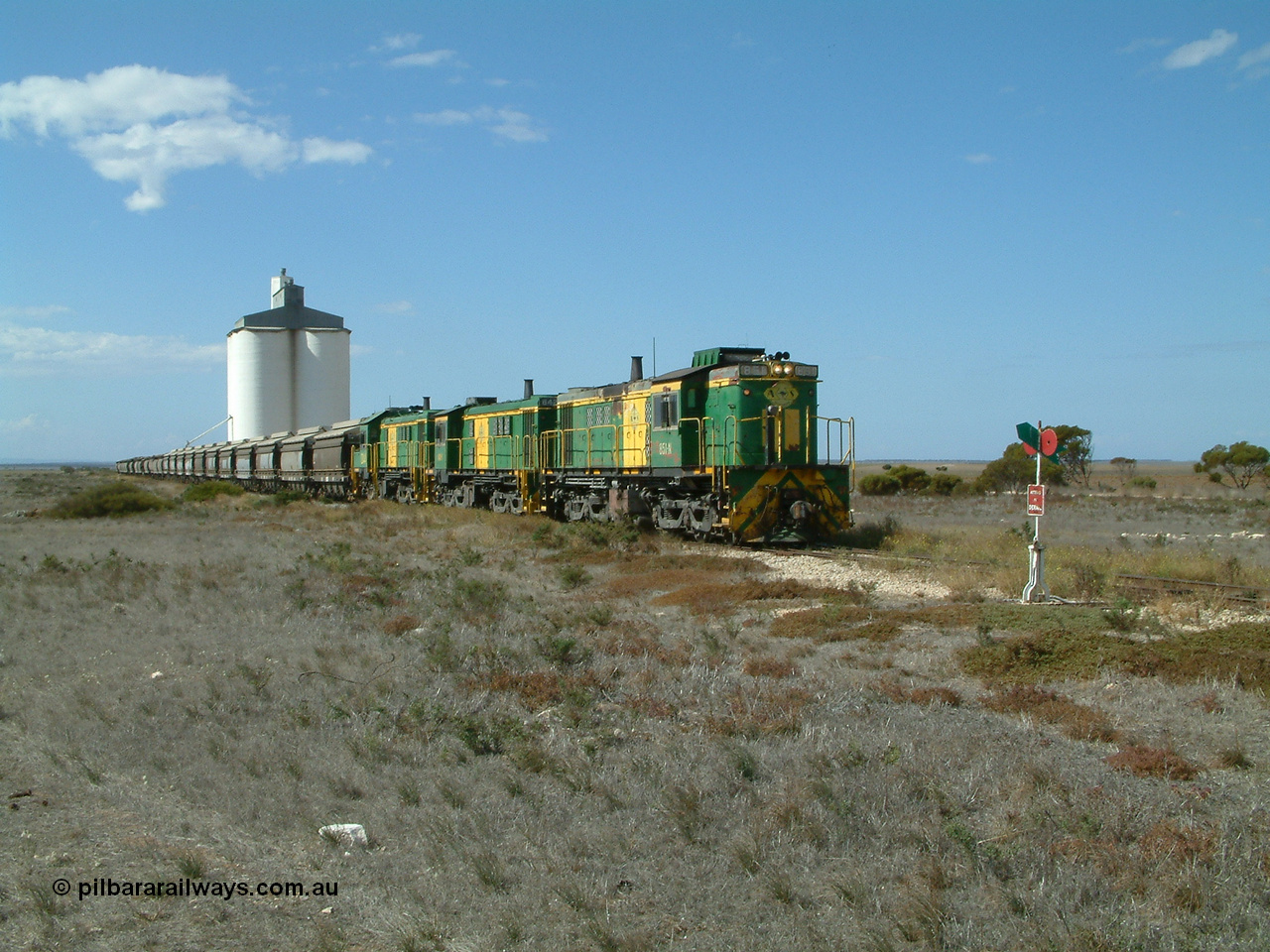 030409 140620
Wharminda, loaded grain train arrives behind 830 class unit 851 AE Goodwin ALCo model DL531 serial 84137, 851 has spent its entire operating career on the Eyre Peninsula, with fellow 830 class 842 serial 84140 and a rebuilt unit DA 4 as they stop to pick up loaded waggons.
Keywords: 830-class;851;84137;AE-Goodwin;ALCo;DL531;