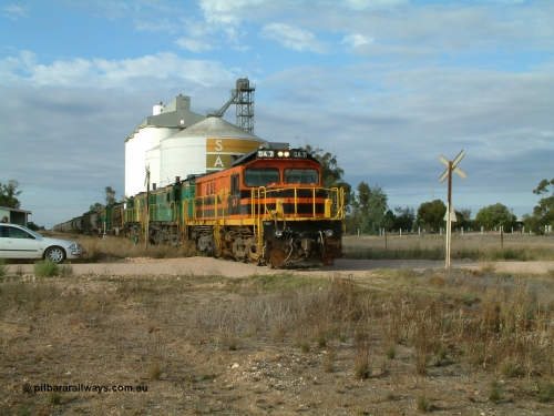 030409 080705
Warramboo, empty grain prepares to get underway following a crew change. Rebuild unit DA 7 in Australian Southern orange and black livery leads a pair of AE Goodwin built ALCo model DL531 830 class units 872 and 871, the long disused station building at left and the SACBH concrete silo complex behind.
Keywords: DA-class;DA7;83713;Port-Augusta-WS;ALCo;DL531G/1;48-class;4813;rebuild;
