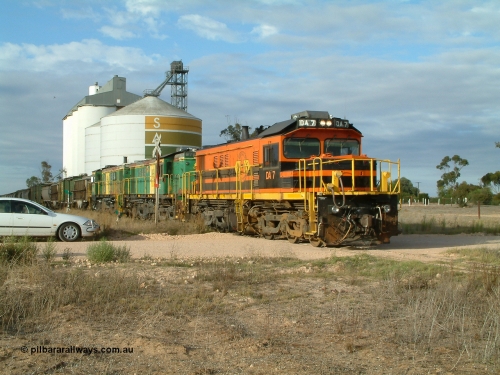 030409 080717
Warramboo, empty grain prepares to get underway following a crew change. Rebuild unit DA 7 in Australian Southern orange and black livery leads a pair of AE Goodwin built ALCo model DL531 830 class units 872 and 871, the relieved crew get in their car with the SACBH concrete silo complex behind.
Keywords: DA-class;DA7;83713;Port-Augusta-WS;ALCo;DL531G/1;48-class;4813;rebuild;
