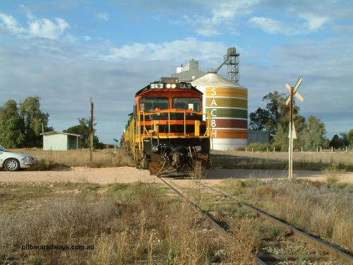 030409 080822
Warramboo, empty grain prepares to get underway following a crew change. Rebuild unit DA 7 in Australian Southern orange and black livery leads a pair of AE Goodwin built ALCo model DL531 830 class units 872 and 871, the relieved crew in the car with the long disused station building on the left and the SACBH concrete silo complex on the right rounding out the scene.
Keywords: DA-class;DA7;83713;Port-Augusta-WS;ALCo;DL531G/1;48-class;4813;rebuild;