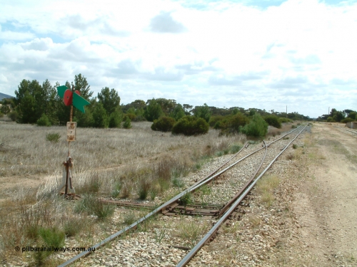 030409 112332
Darke Peake, view looking north from the south end of the triangle, point lever with rail just visible heading into the bush, goods and grain siding with loading ramp at far right.
