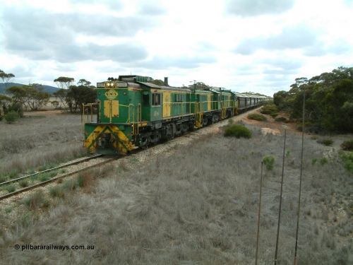 030409 115600
Darke Peake, at the 195 km Dog Fence Road grade crossing loaded grain train with 830 class unit 851 AE Goodwin ALCo model DL531 serial 84137, 851 has spent its entire operating career on the Eyre Peninsula, leads fellow 830 class 842 serial 84140 and a rebuilt unit DA 4, rebuilt from 830 class unit 839 by Port Augusta Workshops, retains original serial 83730 and model DL531 with the first twelve waggons behind the locos XNW type.
Keywords: 830-class;851;AE-Goodwin;ALCo;DL531;84137;