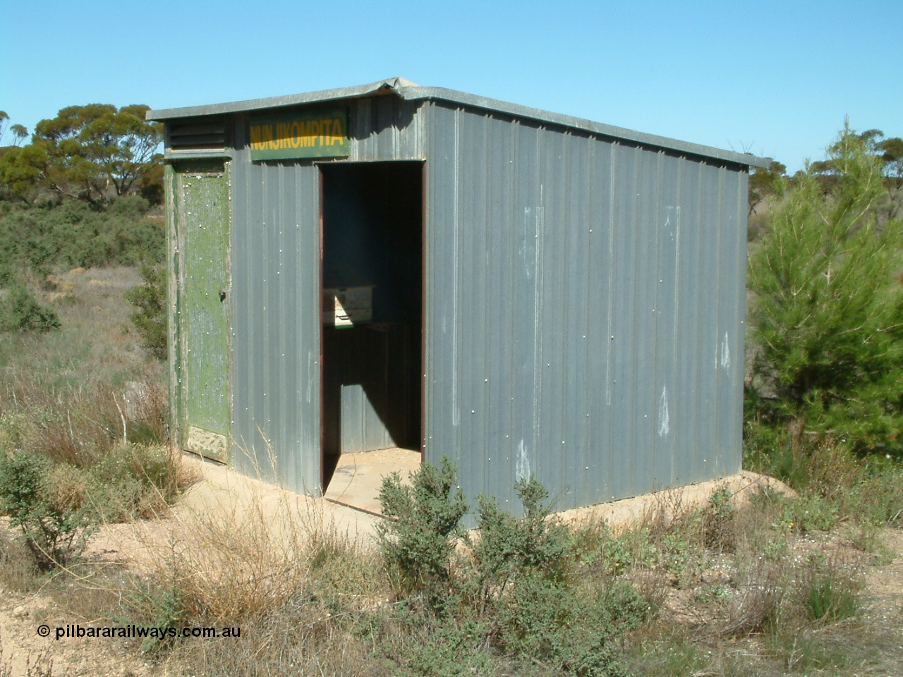 030411 141342
Nunjikompita, aboriginal word for 'burnt hair', located , terminus of line from 14th August 1914 until Thevenard extension opened on the 8th of February 1915, 'station' shelter shed, consignment register desk still in situ.
