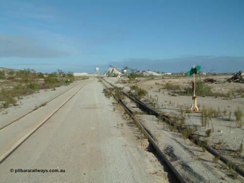 030414 163944
Kevin, looking south at the gypsum plant, the triangle can be seen branching off on the right, loop on the left, the mainline to Penong continues on behind the camera.

