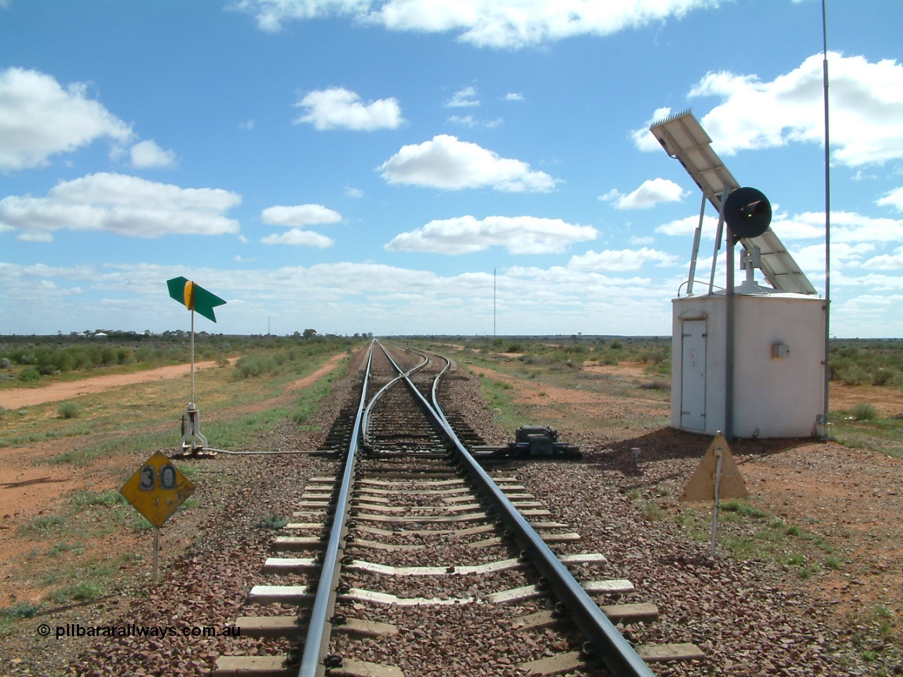 030415 135207
Kingoonya, located at the 426.5 km looking west along the Trans Australian Railway shows 1800 metre long loop on the right, 30 km/h speed restriction and interlocking hut, the town is located over on the left. [url=https://goo.gl/maps/7TMcikXj33EqWvyCA]GeoData location[/url].
