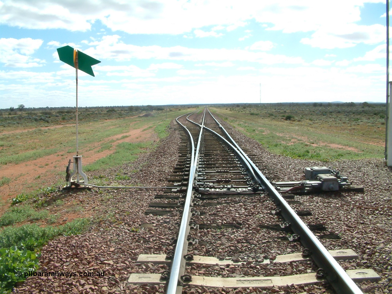 030415 145938
Ferguson, located at the 469 km on the Trans Australian Railway, looking west at the east end of the 1800 metre long crossing loop, point work on timber sleepers, indicator and lever with dual control point machine on the right. [url=https://goo.gl/maps/XNaMGCNxZ4yv7Lrr9]GeoData location[/url].
