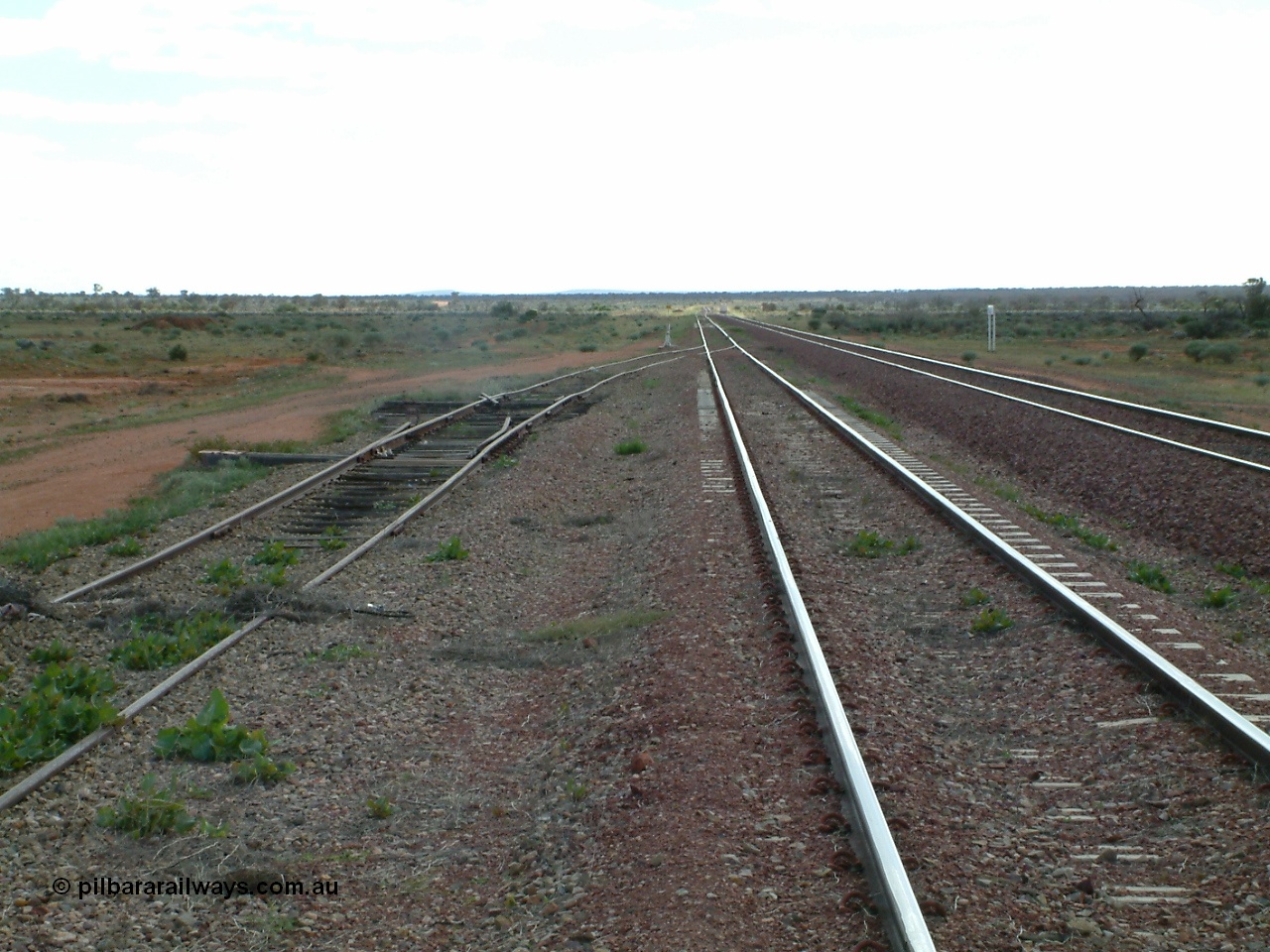 030415 150437
Ferguson, located at the 469 km on the Trans Australian Railway, looking west along the 1800 metre long crossing loop, siding point work on timber sleepers for west end of goods siding with the remains of another set of points. [url=https://goo.gl/maps/XNaMGCNxZ4yv7Lrr9]GeoData location[/url].

