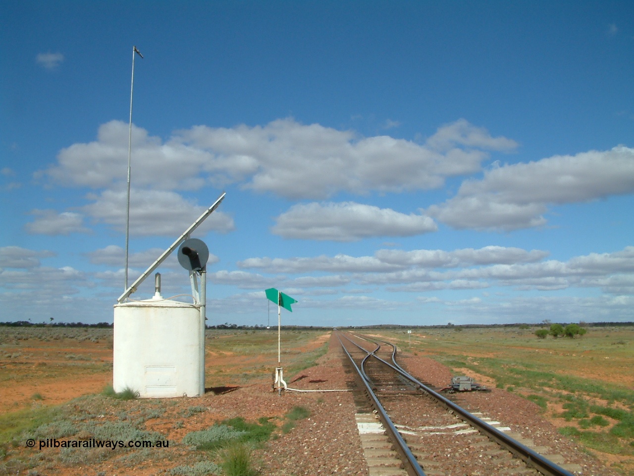 030415 150814
Ferguson, located at the 469 km on the Trans Australian Railway, looking east at the west end of the 1800 metre long crossing loop, point work on timber sleepers, interlocking hut, indicator and lever with dual control point machine on the right. [url=https://goo.gl/maps/XNaMGCNxZ4yv7Lrr9]GeoData location[/url].
